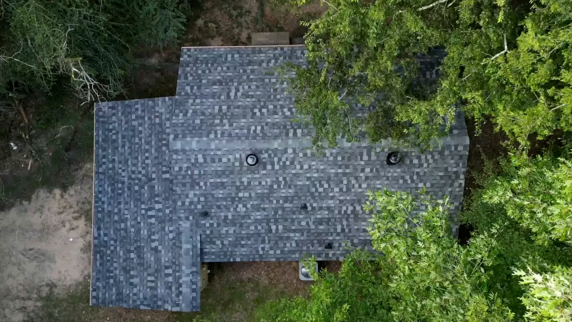 Overhead view of blended charcoal and gray architectural shingles on a finished roof